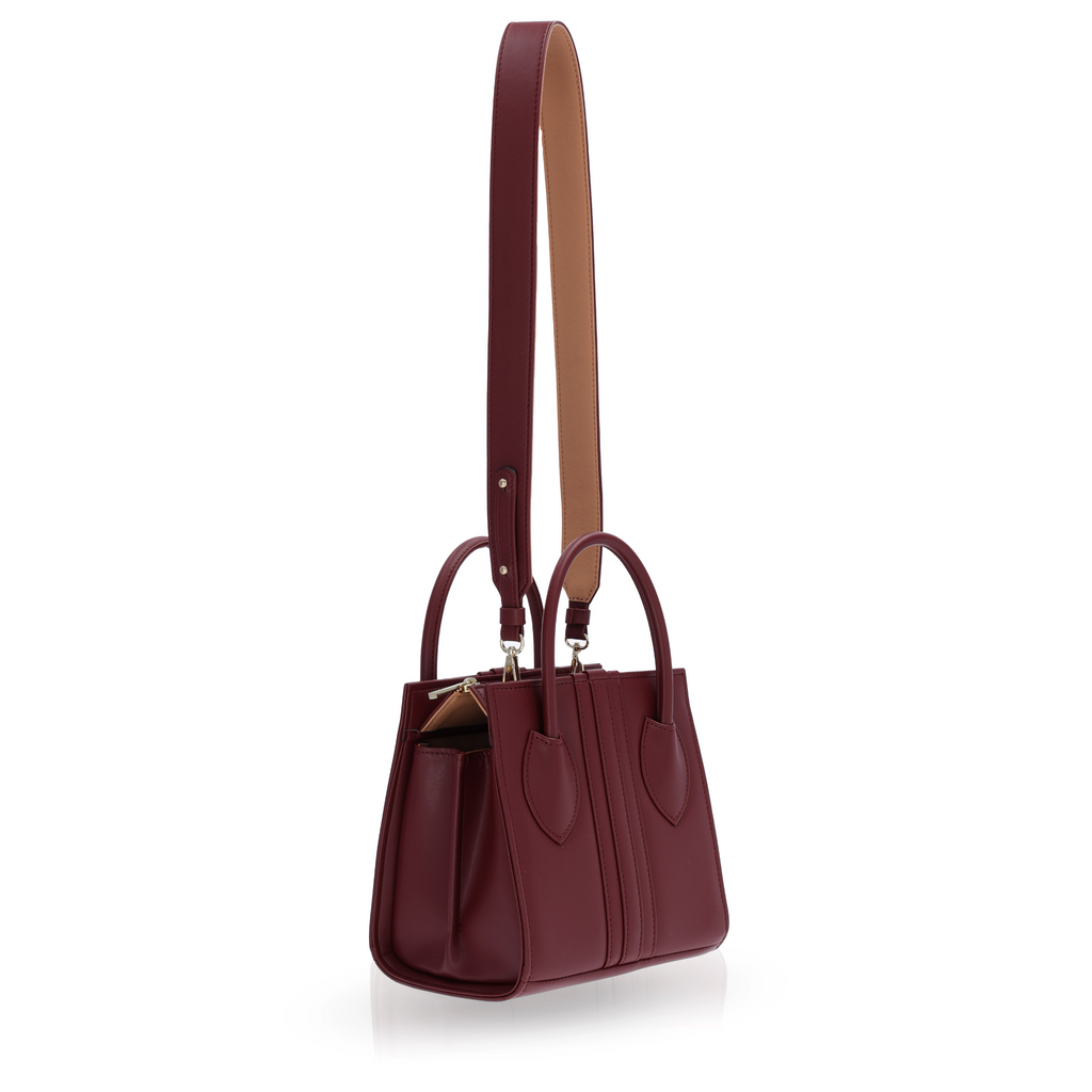 medium-sized burgundy handbag with strap